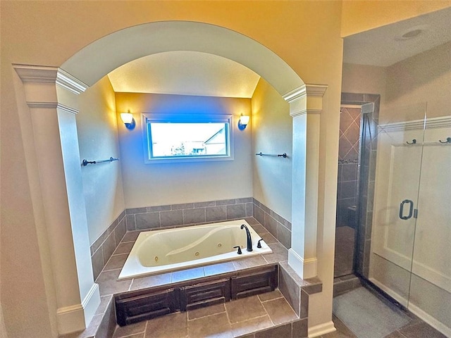 full bathroom with a stall shower, a jetted tub, and decorative columns