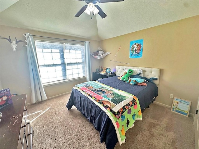 bedroom featuring lofted ceiling, a textured ceiling, carpet, baseboards, and ceiling fan