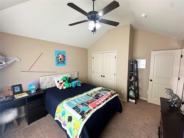 bedroom with baseboards, vaulted ceiling, carpet flooring, a closet, and a ceiling fan