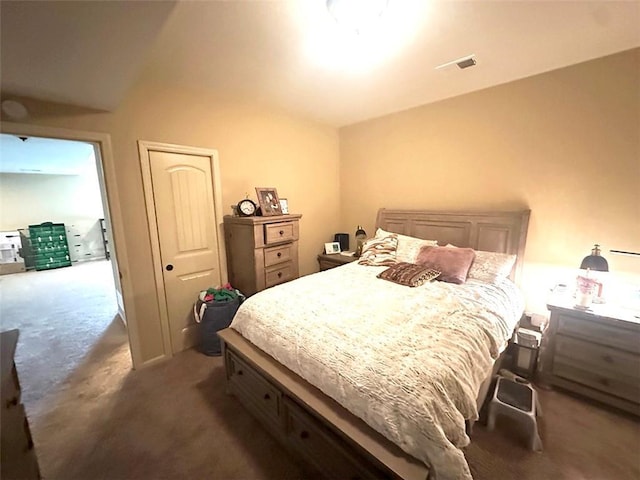 carpeted bedroom featuring visible vents and vaulted ceiling