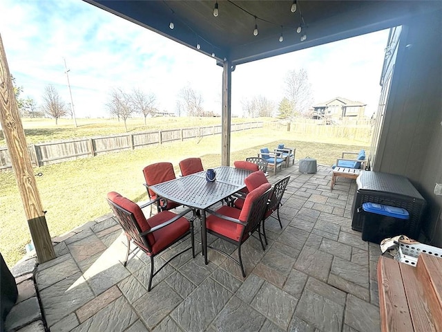 view of patio with outdoor dining space and a fenced backyard