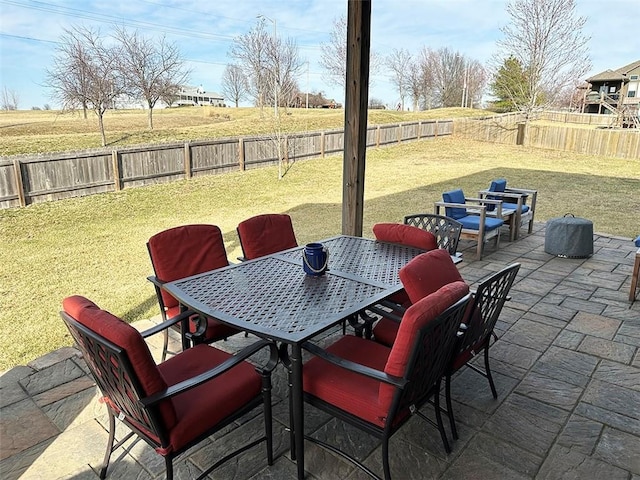 view of patio with outdoor dining area and a fenced backyard