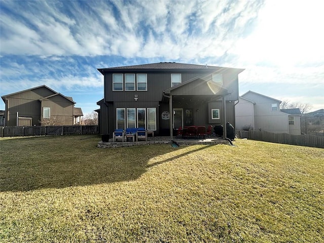 back of house with a patio, a lawn, and fence