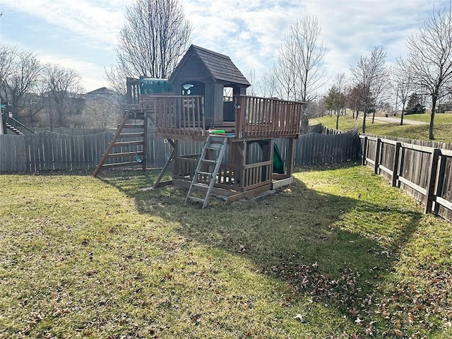 view of playground with a lawn and a fenced backyard