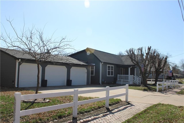 single story home featuring a garage, concrete driveway, and fence