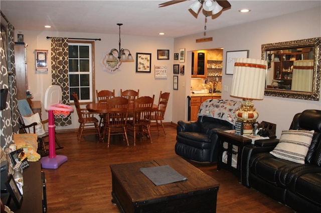 living room with recessed lighting, ceiling fan with notable chandelier, and wood finished floors