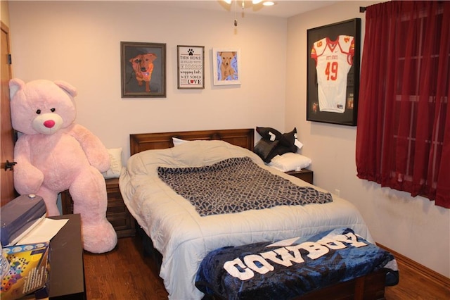 bedroom featuring wood finished floors and baseboards