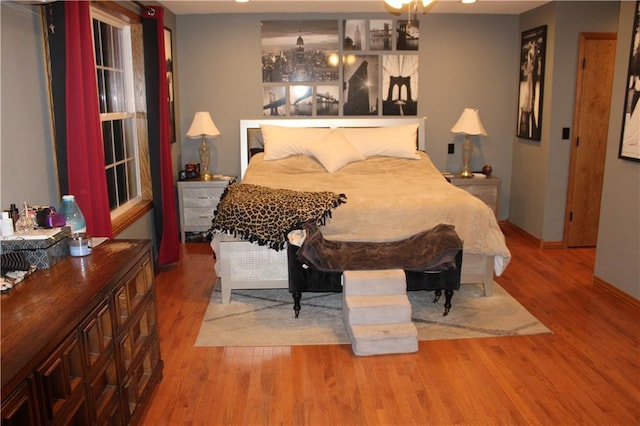 bedroom featuring wood finished floors and baseboards