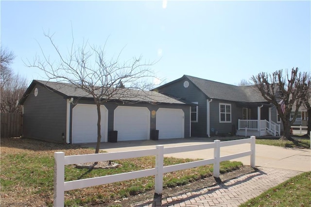 ranch-style home with a garage, driveway, and fence