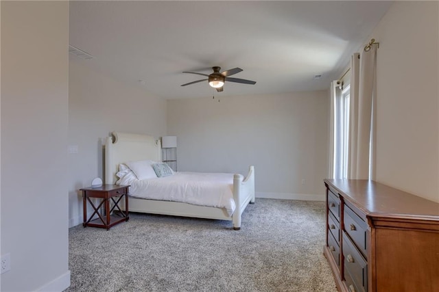 bedroom featuring baseboards, light colored carpet, and ceiling fan