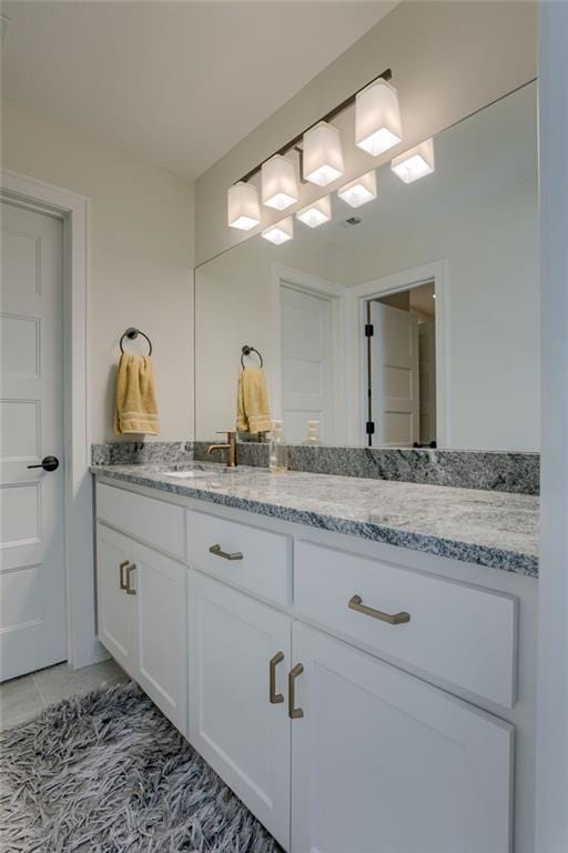 bathroom with a sink and double vanity