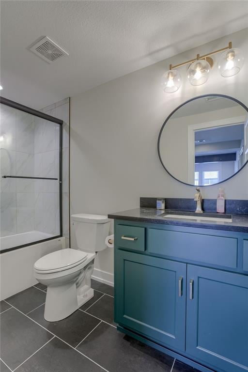 full bathroom featuring vanity, visible vents, a textured ceiling, tile patterned floors, and toilet