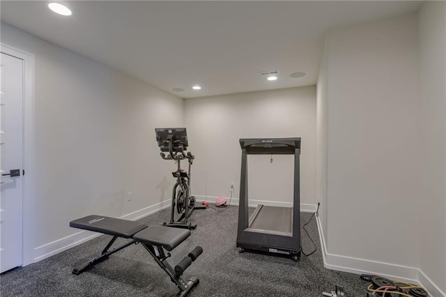 workout area featuring recessed lighting and baseboards