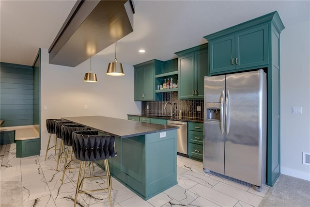 kitchen featuring stainless steel appliances, dark countertops, marble finish floor, and green cabinets