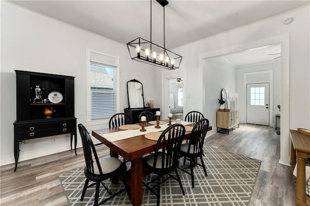 dining area featuring an inviting chandelier and wood finished floors