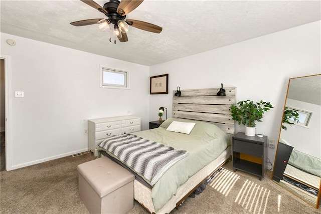 bedroom with a textured ceiling, baseboards, carpet floors, and ceiling fan