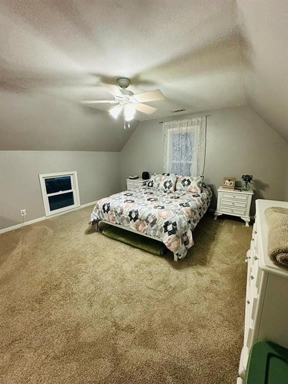 bedroom with dark carpet, vaulted ceiling, a textured ceiling, and a ceiling fan