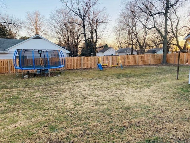 view of yard featuring a fenced backyard and a trampoline
