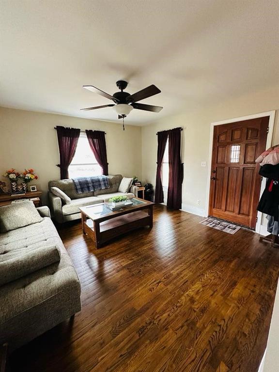 living room with wood finished floors and ceiling fan