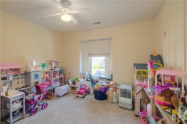 playroom with carpet flooring, visible vents, and ceiling fan