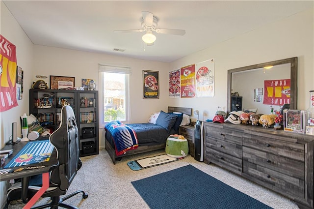 carpeted bedroom with visible vents and a ceiling fan