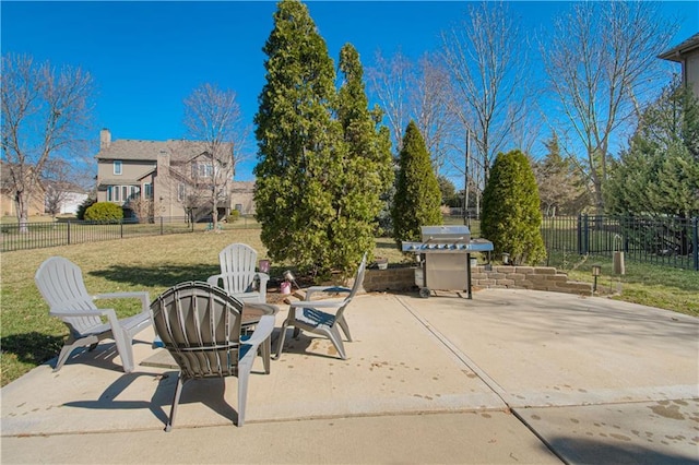 view of patio featuring a grill and fence