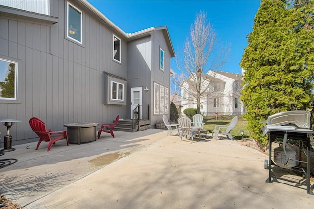 view of patio featuring a grill, fence, and an outdoor fire pit