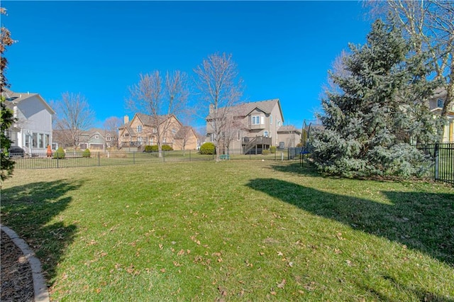 view of yard with a residential view and a fenced backyard