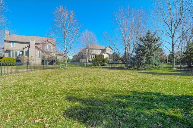 view of yard featuring a trampoline and a fenced backyard