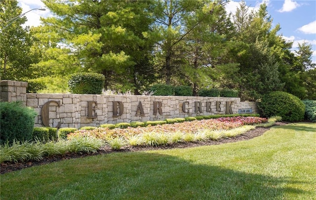 community sign featuring a lawn