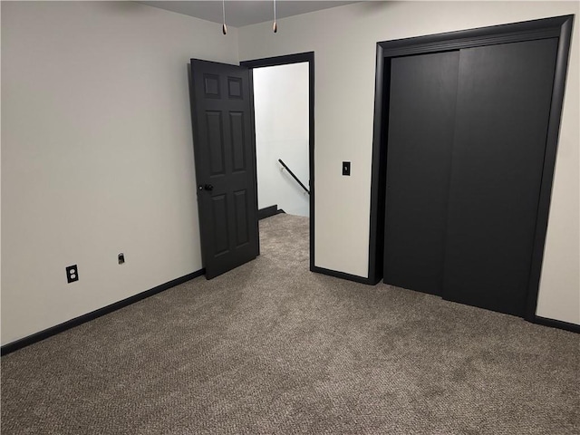 unfurnished bedroom with baseboards, light carpet, elevator, and a closet