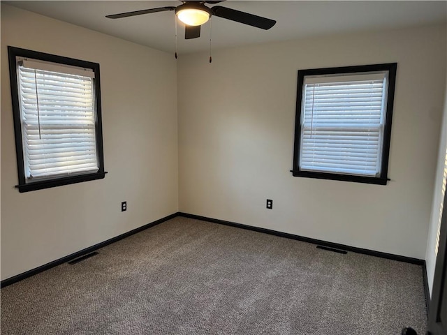 unfurnished room with visible vents, ceiling fan, baseboards, and carpet floors