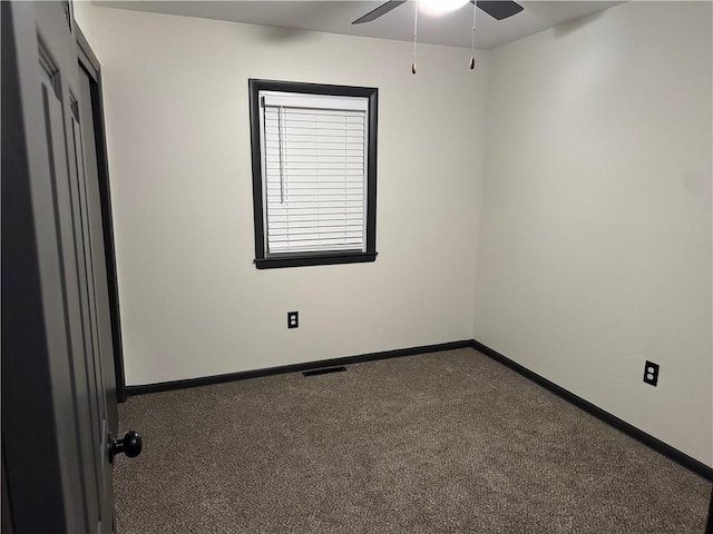 spare room featuring visible vents, carpet floors, baseboards, and ceiling fan