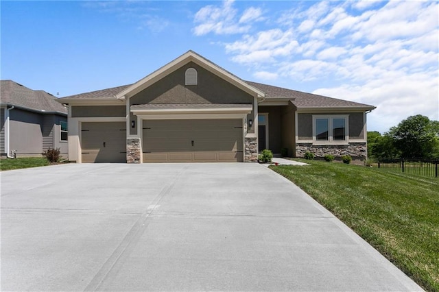 view of front of house with stone siding, stucco siding, a front yard, and a garage