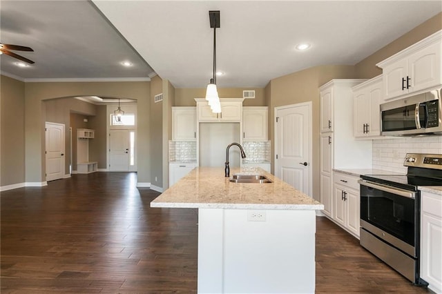 kitchen featuring a sink, stainless steel appliances, light stone counters, and dark wood-style flooring