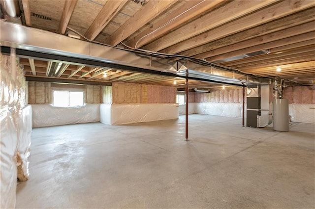 basement featuring heating unit and water heater