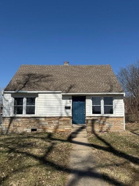 view of front of home with stone siding and a shingled roof