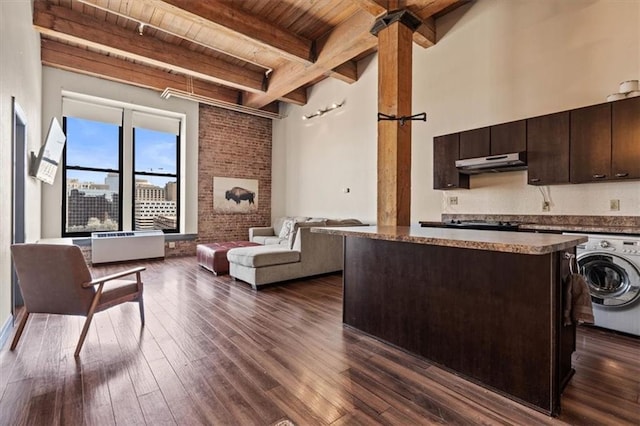 308 W 8th St Unit 414, Kansas City, MO 64105 - living area with a wooden ceiling with exposed beams, washer / dryer, and dark wood finished floors