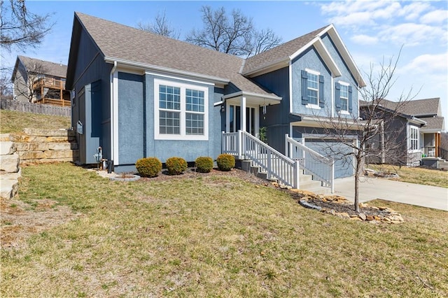 split level home featuring a front lawn, concrete driveway, an attached garage, and fence