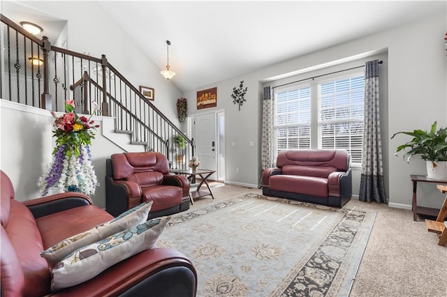 living area featuring stairway, baseboards, carpet, and vaulted ceiling