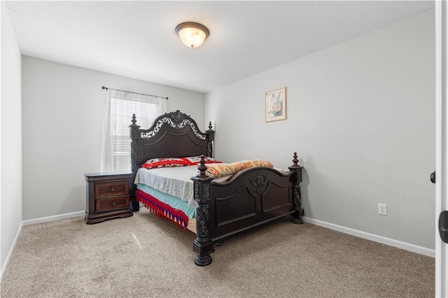 carpeted bedroom featuring baseboards