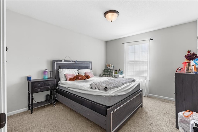 bedroom featuring baseboards and light colored carpet