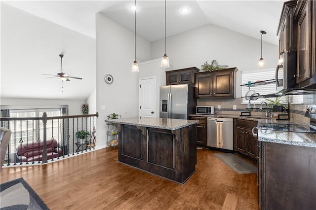 kitchen with light stone counters, dark wood-style flooring, ceiling fan, stainless steel appliances, and dark brown cabinetry