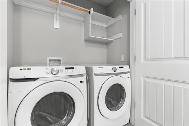 washroom with independent washer and dryer and laundry area