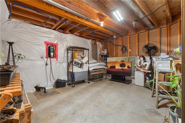 unfinished basement featuring electric panel