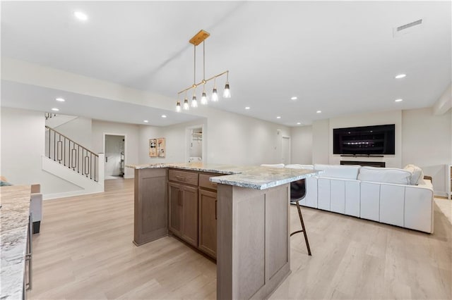 kitchen with visible vents, light wood-style flooring, recessed lighting, and open floor plan