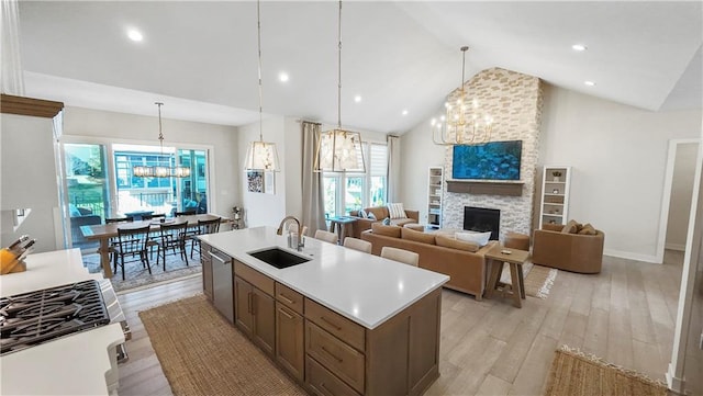 kitchen featuring an inviting chandelier, light countertops, light wood finished floors, and a sink