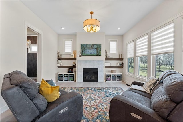 living room featuring a fireplace, wood finished floors, a healthy amount of sunlight, and baseboards