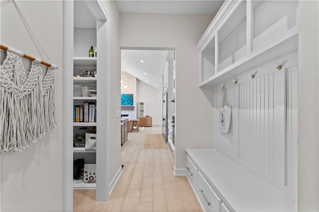 mudroom featuring vaulted ceiling, recessed lighting, and light wood-type flooring