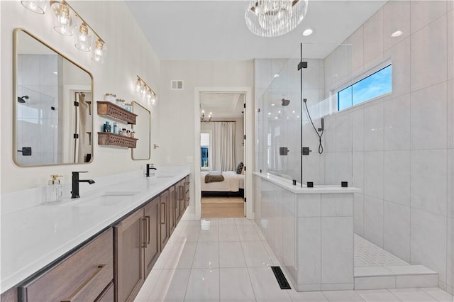 full bathroom with walk in shower, a notable chandelier, visible vents, and a sink